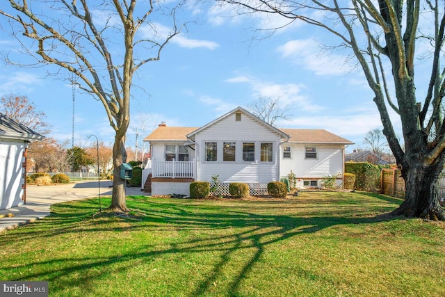 rear view of house with a yard