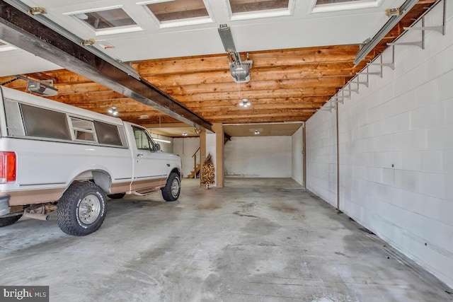 garage with a carport and a garage door opener