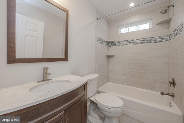 full bathroom featuring toilet, bathing tub / shower combination, and vanity