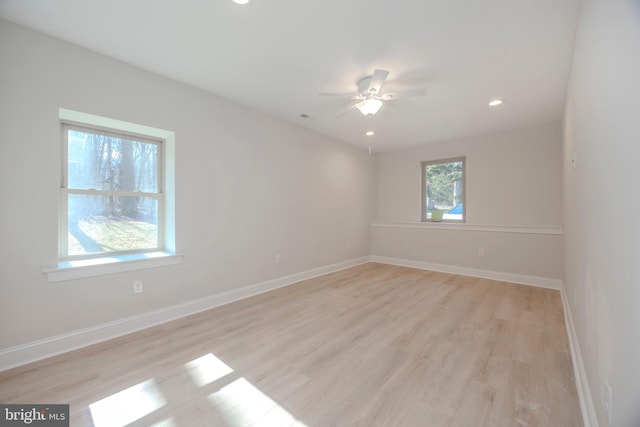 spare room with light wood-type flooring, ceiling fan, baseboards, and recessed lighting