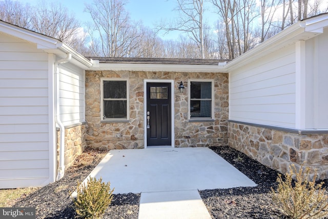 property entrance with stone siding