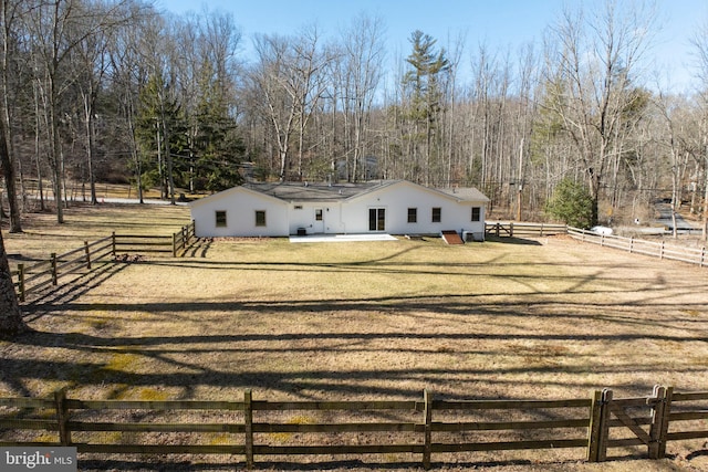 view of front of property with a front yard, fence, and a patio