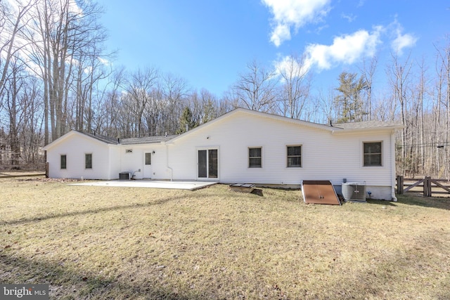 rear view of property featuring a yard, a patio area, fence, and central air condition unit