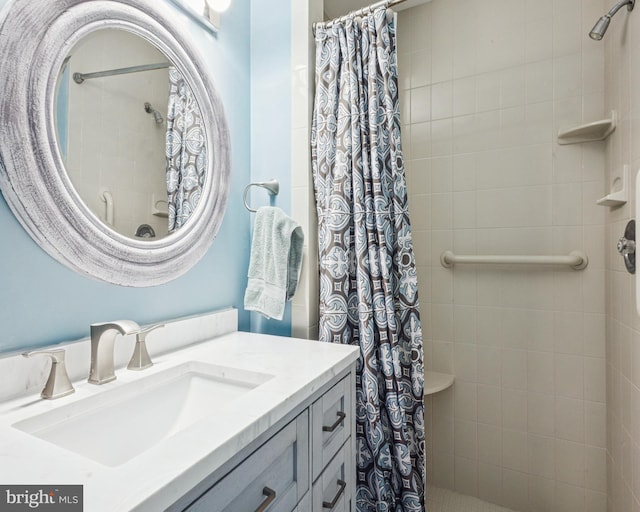 full bathroom with tiled shower and vanity