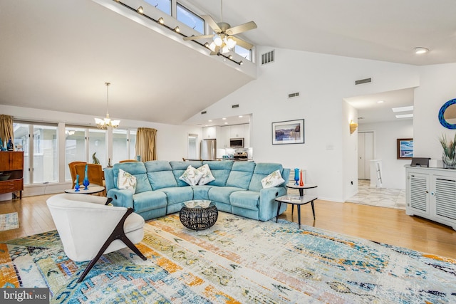 living area with light wood-style floors, visible vents, and ceiling fan with notable chandelier