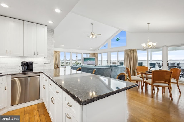 kitchen featuring ceiling fan with notable chandelier, a peninsula, a wealth of natural light, and light wood-style floors