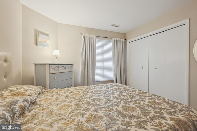 bedroom with a closet and visible vents