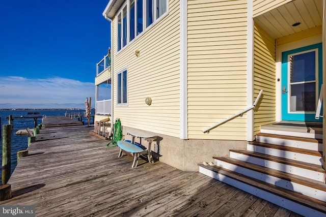 deck featuring entry steps and a water view