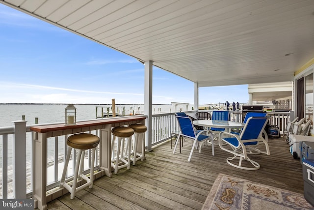 wooden terrace featuring a water view