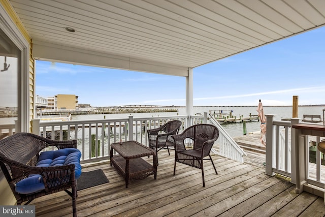 wooden terrace featuring a water view