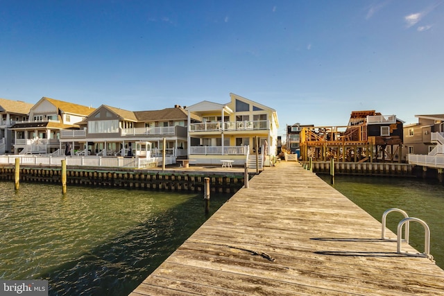 dock area with a water view and a residential view