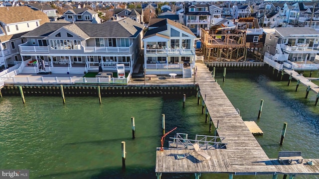 dock area featuring a water view and a residential view