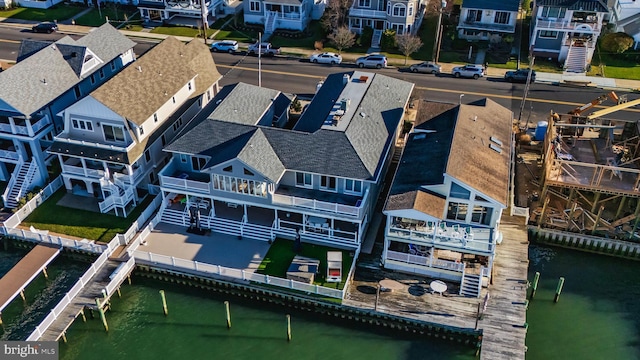 bird's eye view featuring a water view and a residential view