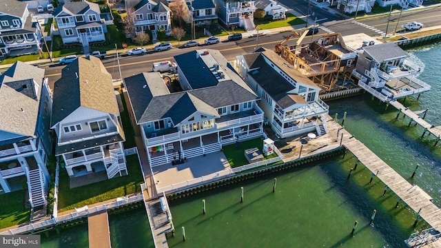 drone / aerial view with a water view and a residential view