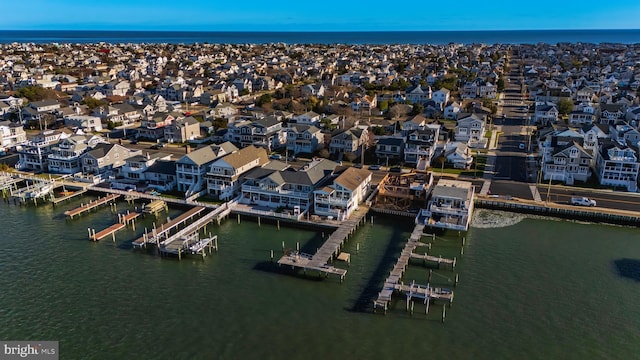 drone / aerial view with a water view and a residential view