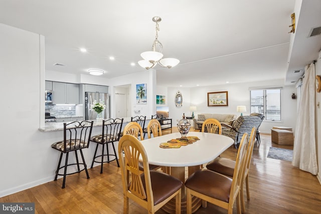 dining area featuring recessed lighting, visible vents, baseboards, and wood finished floors