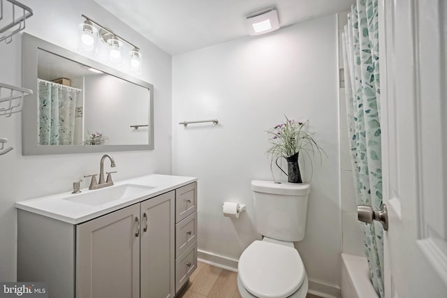 bathroom featuring vanity, hardwood / wood-style floors, and toilet