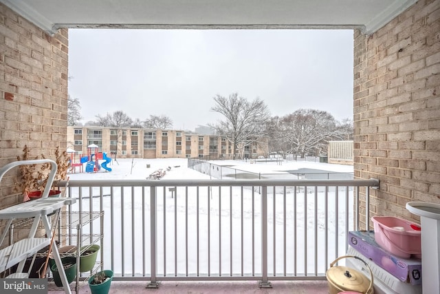 view of snow covered back of property