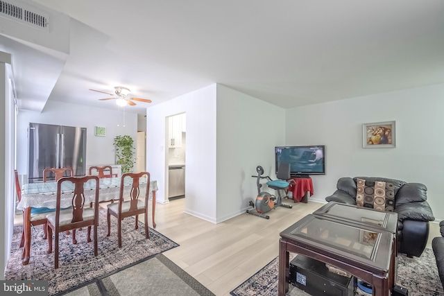 living room featuring ceiling fan and light wood-type flooring