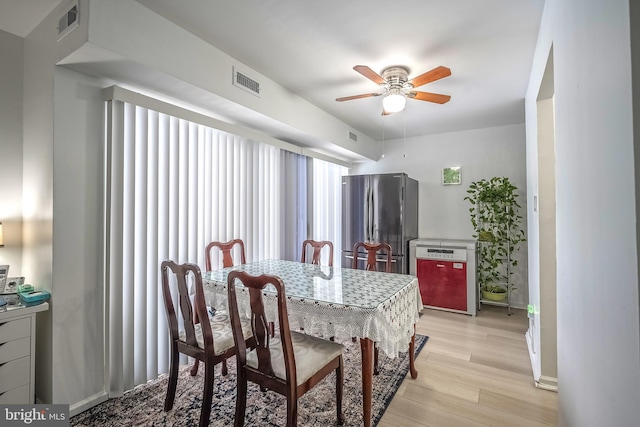 dining room with ceiling fan and light hardwood / wood-style floors