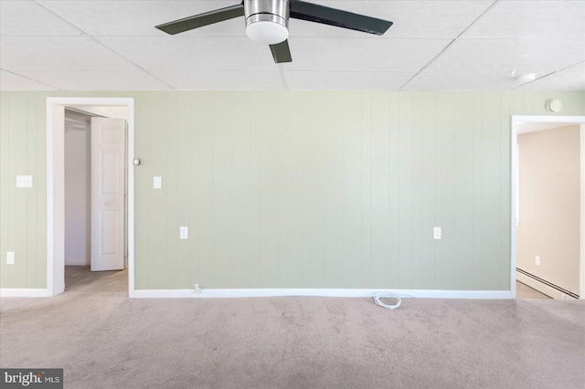 empty room featuring ceiling fan, a paneled ceiling, light carpet, and baseboard heating