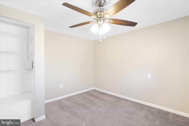 carpeted empty room featuring ceiling fan