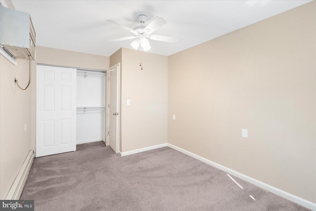 unfurnished bedroom with a baseboard radiator, carpet flooring, ceiling fan, and a closet