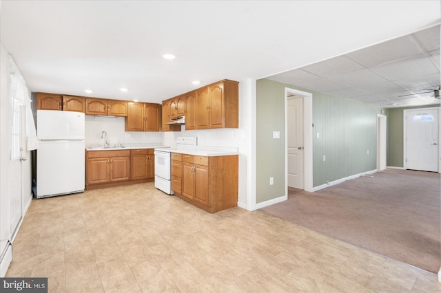 kitchen featuring sink, white appliances, light colored carpet, and baseboard heating