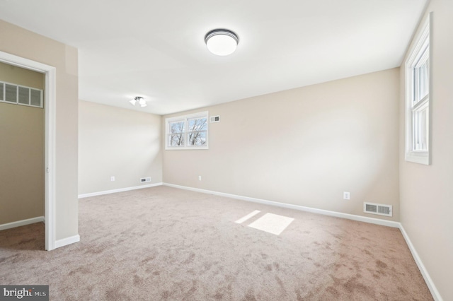 interior space featuring carpet floors, visible vents, and baseboards