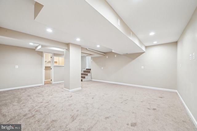 finished below grade area featuring carpet floors, stairway, baseboards, and recessed lighting