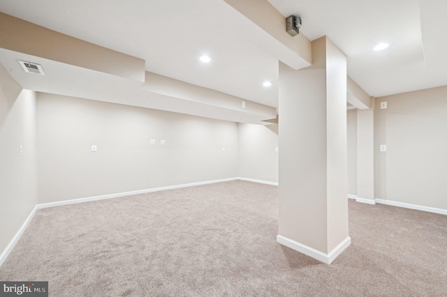 finished below grade area with baseboards, recessed lighting, visible vents, and light colored carpet