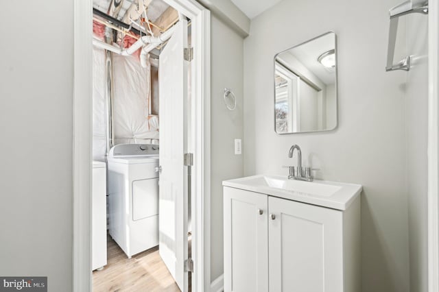 half bathroom with wood finished floors and vanity