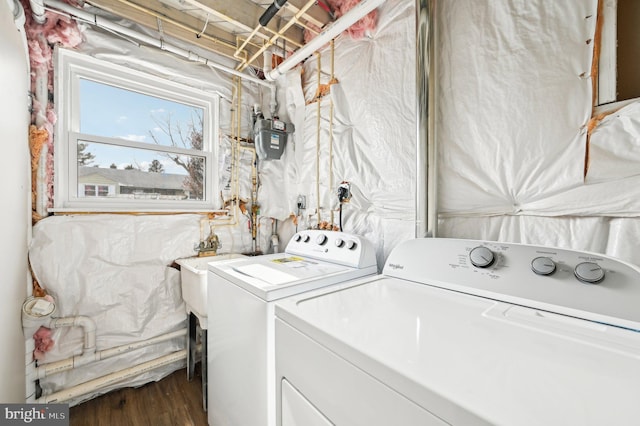 laundry room featuring laundry area, washer and clothes dryer, and wood finished floors