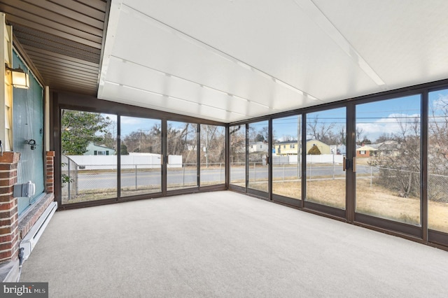 unfurnished sunroom with a baseboard radiator and a residential view