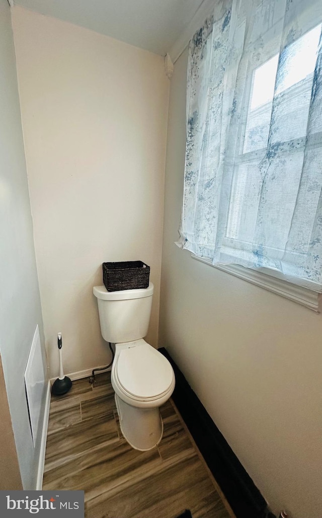 bathroom featuring hardwood / wood-style flooring and toilet