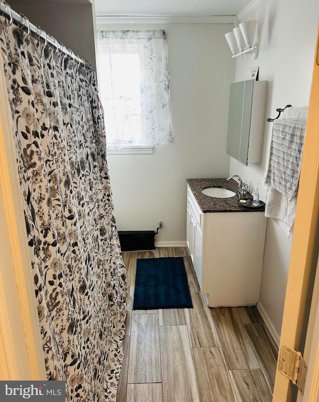 bathroom with vanity and ornamental molding