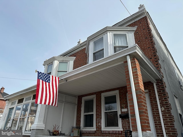 view of side of home featuring a porch