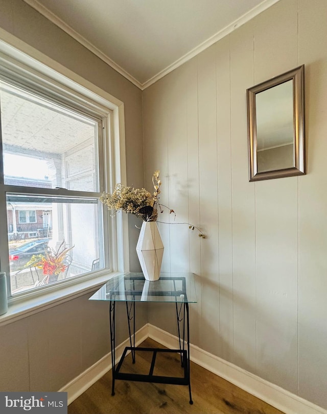 dining space featuring wood-type flooring and ornamental molding