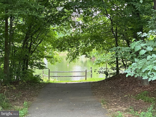 exterior space featuring a water view and fence