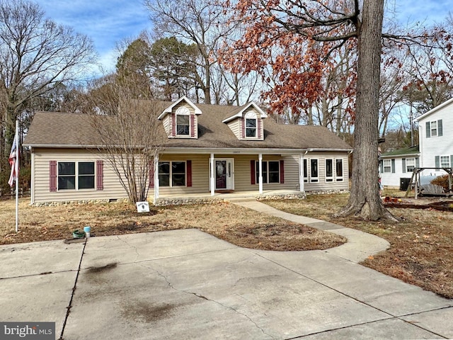 cape cod-style house with covered porch