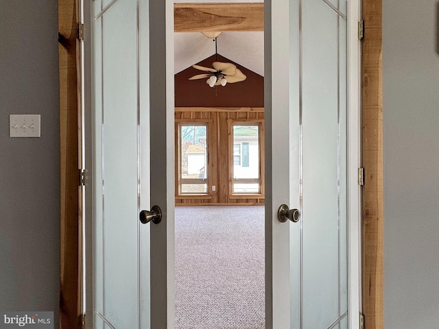 hallway with vaulted ceiling, carpet floors, and french doors