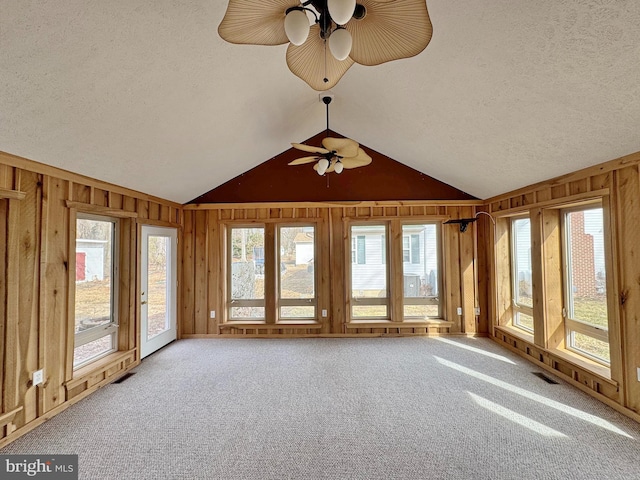 unfurnished sunroom featuring ceiling fan and vaulted ceiling