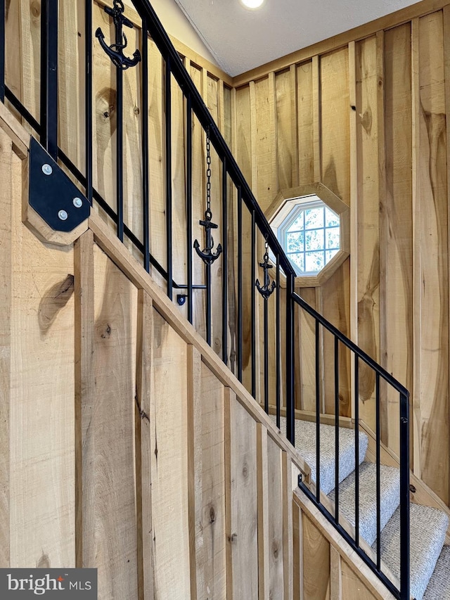 stairs featuring wooden walls