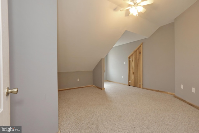 additional living space featuring lofted ceiling, light colored carpet, and ceiling fan