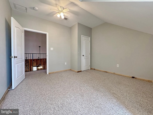 unfurnished bedroom with ceiling fan, lofted ceiling, and carpet