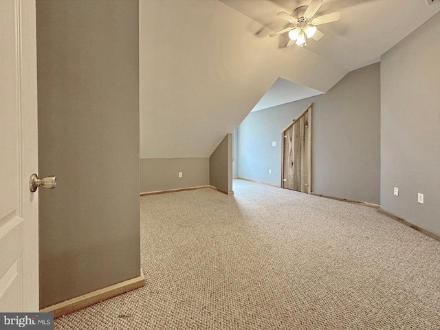 bonus room with lofted ceiling, light colored carpet, and ceiling fan