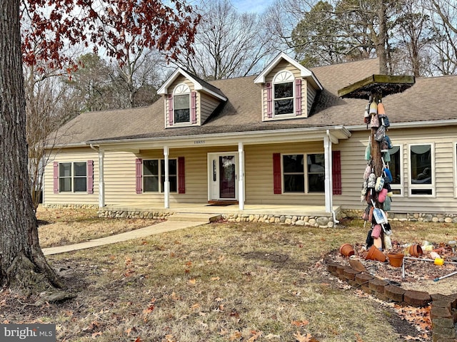 cape cod-style house with covered porch