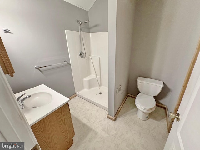 bathroom featuring vanity, toilet, and a shower