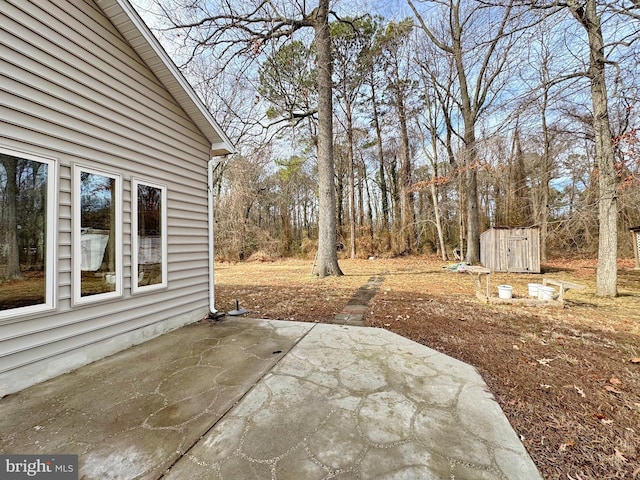 view of patio featuring a storage unit