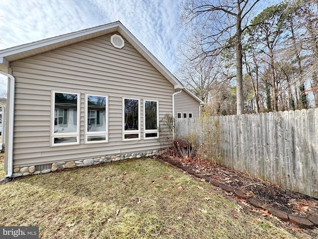 rear view of house featuring a yard